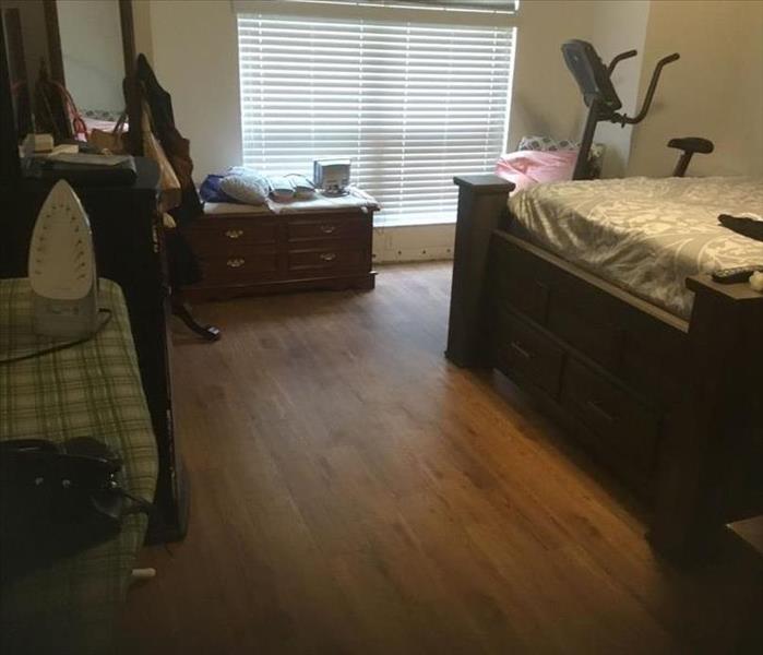 Bedroom with dried floor and furniture