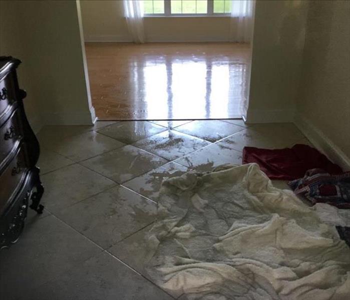 Tile floor with wet sheets and water still on it