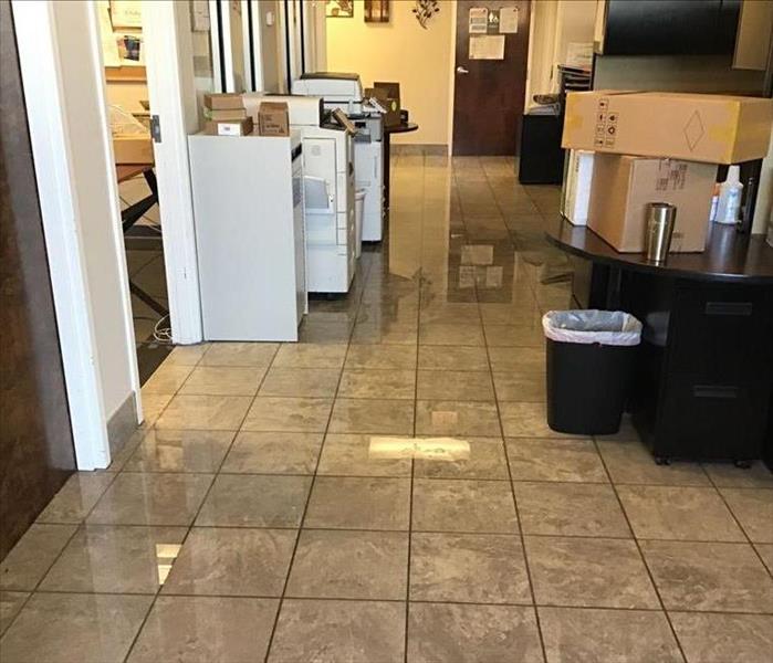 Office with 2 inches of water all over floor and equipment in it.