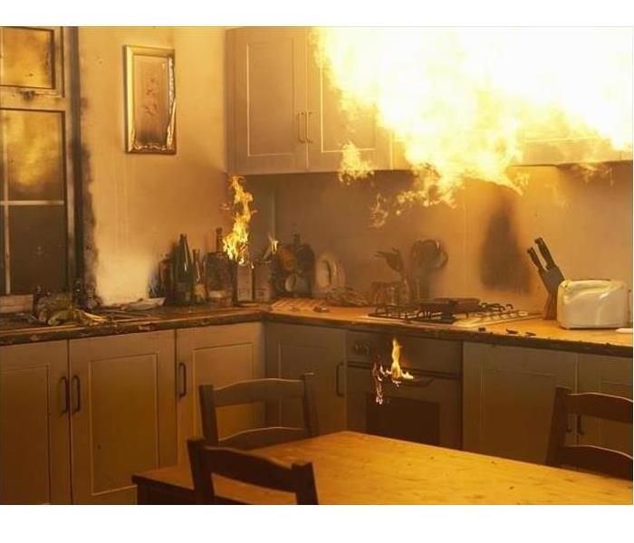 Flames above an oven in a kitchen and cabinets on fire