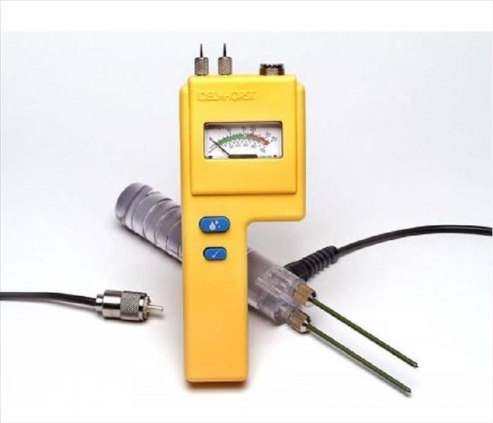 Yellow piece of equipment with prongs on end and adapters to show readings on the screen